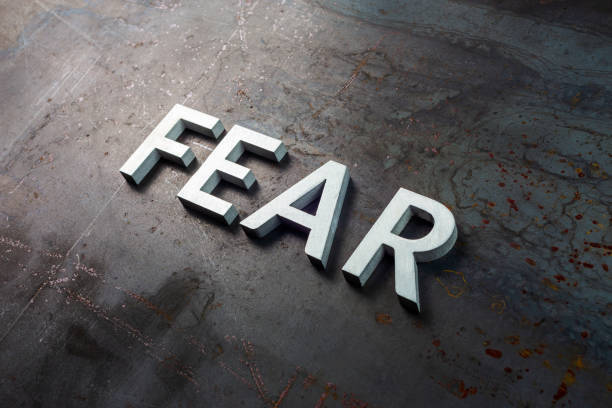 the word fear laid with silver letters on raw rusted steel sheet surface in diagonal slanted composition the word fear laid with silver letters on raw rusted steel sheet surface in slanted diagonal composition Phobia stock pictures, royalty-free photos & images