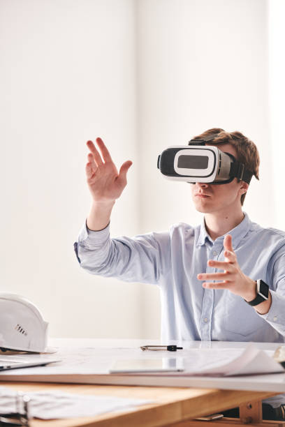 istock Designing 3D model of building with VR device 1215373365