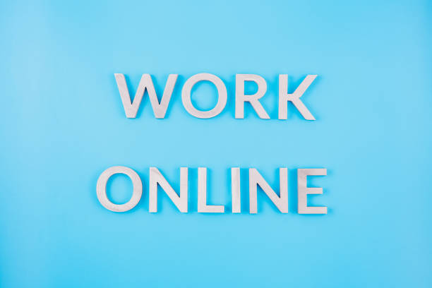 istock the words work online laid with brushed aluminium letters on blue flat surface - close-up with flat lay composition 1215375260