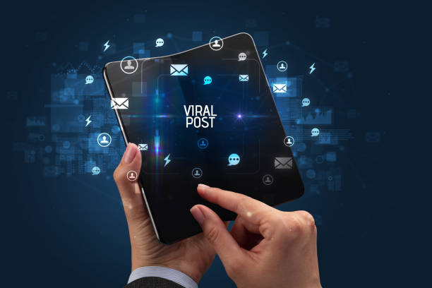 istock Businessman holding a foldable smartphone, social media concept 1215375614
