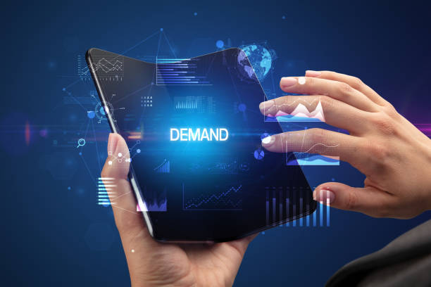 istock Businessman holding a foldable smartphone, business concept 1215375626