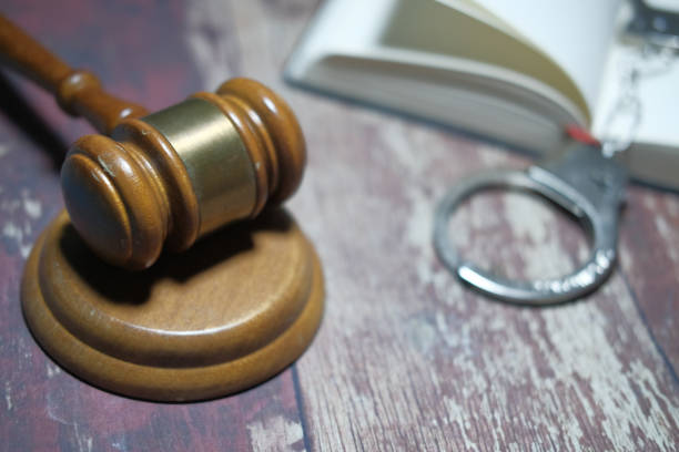 istock Close up of gavel, book and handcuff on table 1215375664