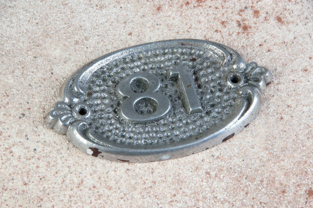 istock Old aluminum number on concrete background 1215376565