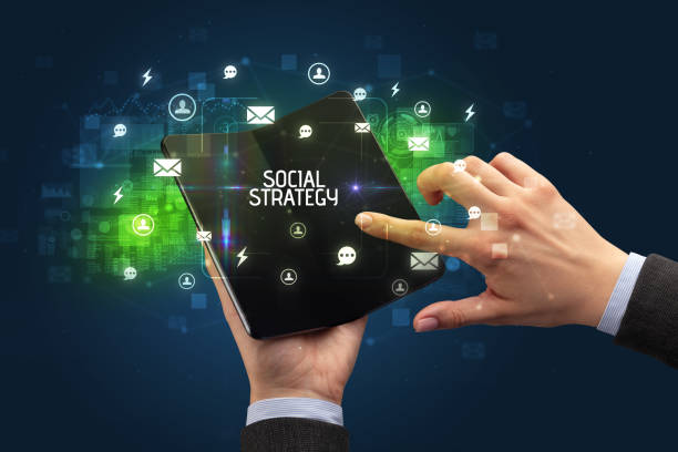 istock Businessman holding a foldable smartphone, social media concept 1215376629