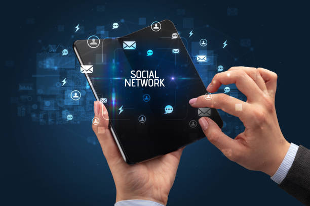 istock Businessman holding a foldable smartphone, social media concept 1215376651