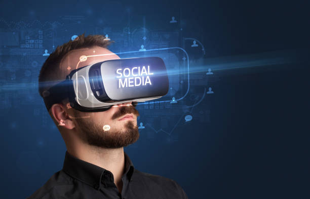 istock Businessman looking through Virtual Reality glasses, social media concept 1215378031