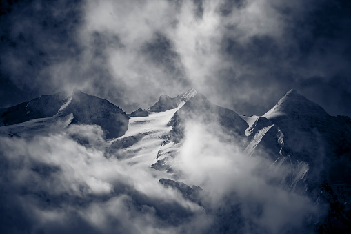 mountain peaks in the clouds in switzerland.
