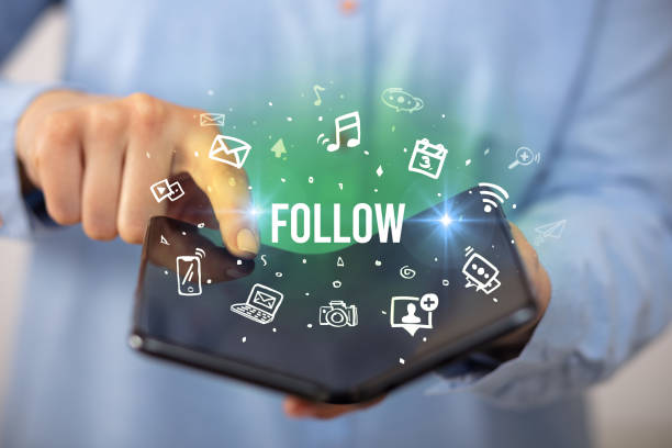 istock Businessman holding a foldable smartphone, social media concept 1215379546