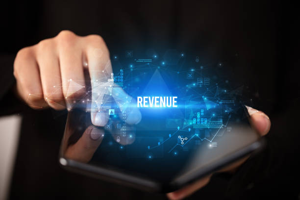 istock Businessman holding a foldable smartphone, business concept 1215380748