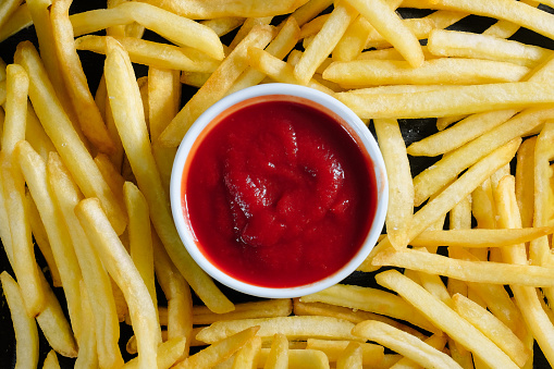Tasty french fries and ketchup close-up. Background, top view.
