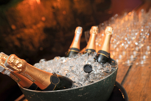 bottle of champagne on cooler with ice\