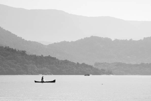 Lone fishermen pulling the net on the coast of the state of Rio de Janeiro, Brazil.