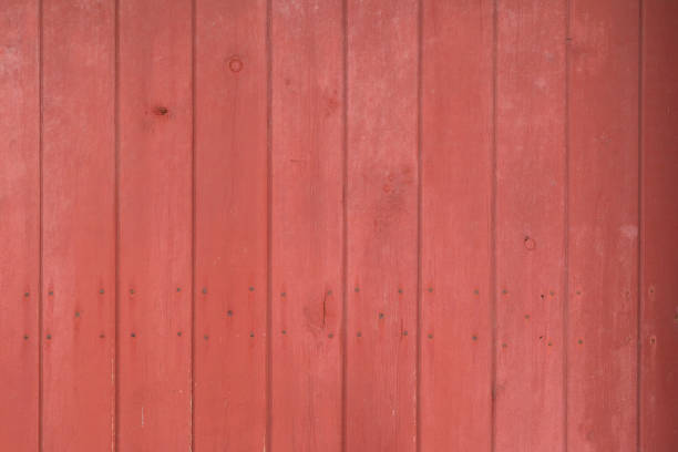 istock Red barn siding with nail holes background 1215385176