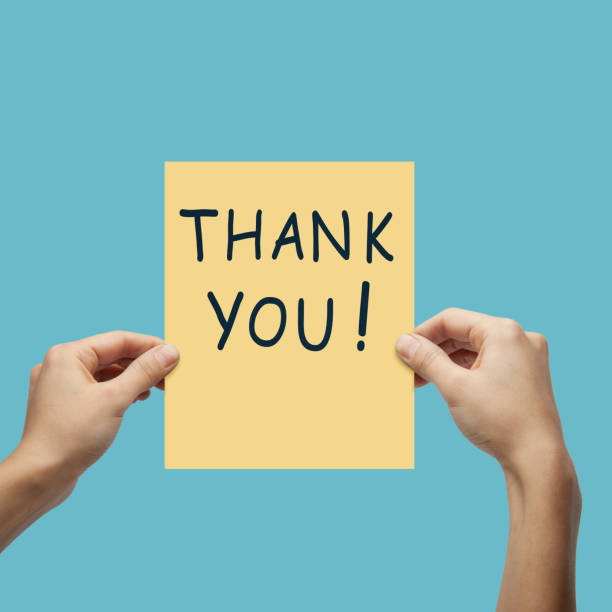 istock Hands Holding Yellow Paper with Thank You Message. 1215386705