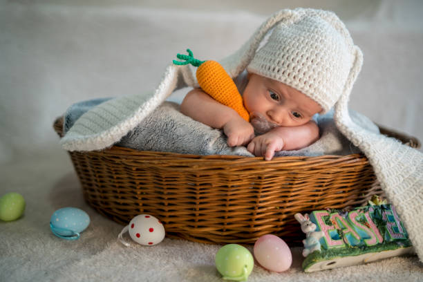 istock baby Easter bunny in basket with eggs 1215388717