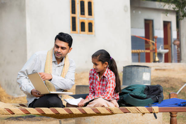 istock Father with daughter using laptop stock photo 1215388849
