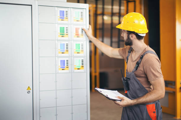 istock Young man in the factory using and checking machines 1215389904