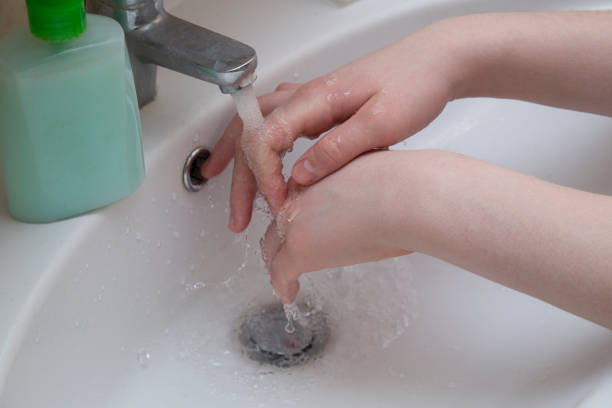 istock A man washes his hands under the tap in the bathroom. 1215390376