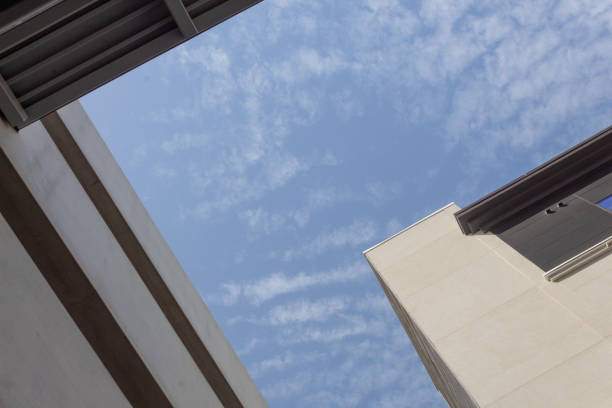 istock Abstract composition of modern buildings against a blue sky on a sunny day 1215392663