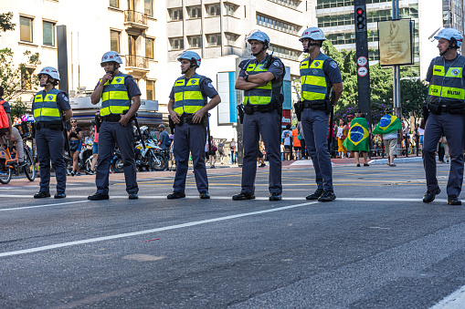 Sso Paulo, Sao Paulo - Brazil - Dec 08, 2019: Uniformed police officers with reflective vests and helmets to contain demonstration