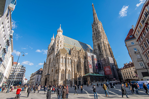 People walking in a pedestrian street next to St. Stephen´s Cathedral at downtown Vienna, Austria.