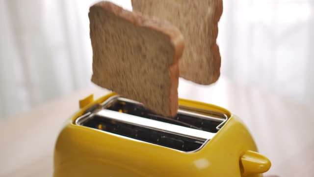 Roasted toast bread popping up from toaster,Slow motion
