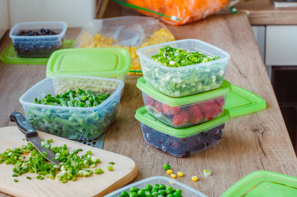 istock Kitchen plastic food boxes with fresh vegetables and berries 1215395509