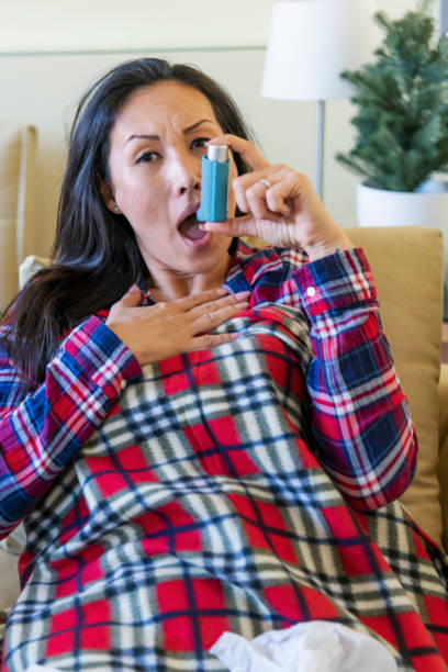 istock Asthmatic Woman with Inhaler- Quarantine 1215397435