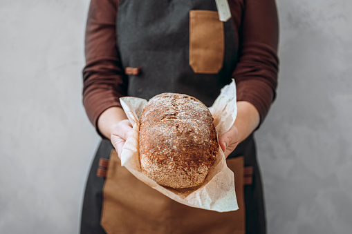 Woman holding freshly baked homemade bread