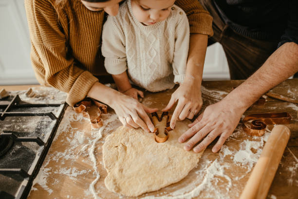istock Young family baking cookies 1215402546