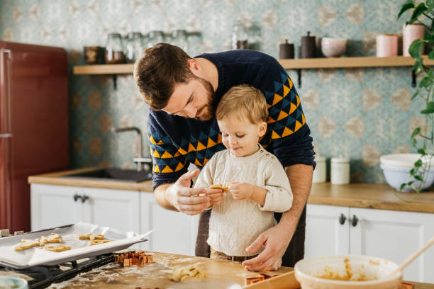 istock Father and son baking cookies 1215403071