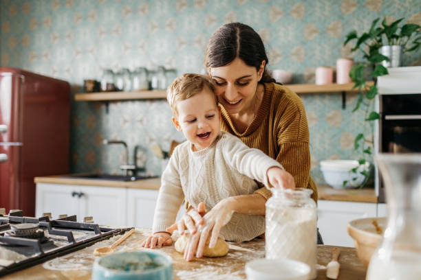 istock Mother and son making dough together 1215404057
