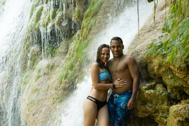 istock Couple in a hugging waterfall 1215405684