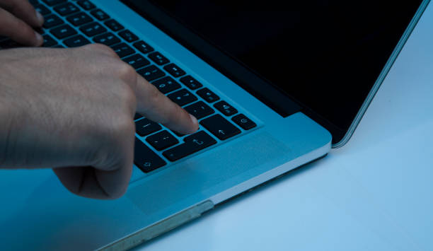 istock Man hand pressing a enter button on a laptop on the white background 1215408270