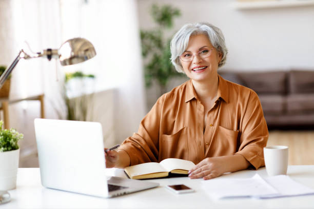 istock Elderly female freelancer smiling for camera 1215409007