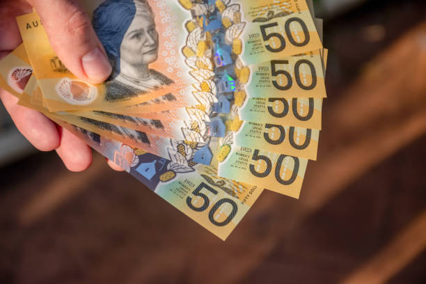 istock Hands holding australian dollars 50 banknotes to make a payment 1215409139