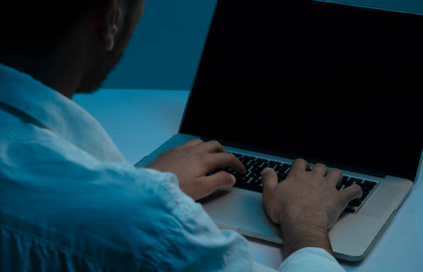 istock Back view of businessman doing research on computer on white desk 1215410038