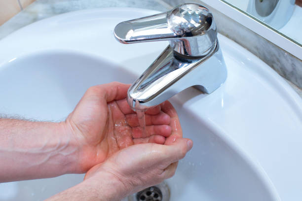 istock A Man is washing his hands with soap in bathroom. 1215413704