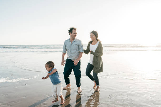 istock Parents playing with kids on the beach 1215413978