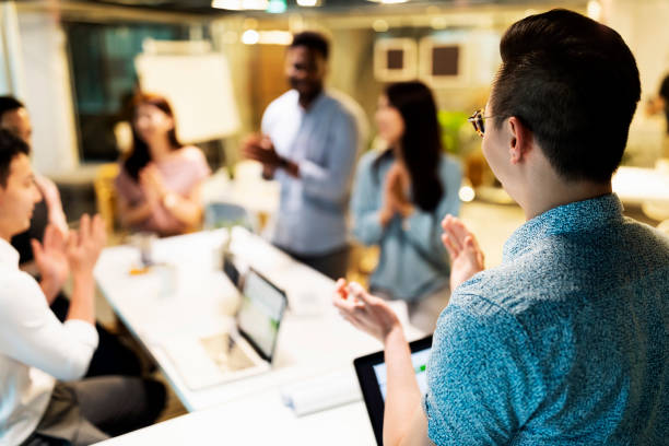 istock Multi-ethnic business team  applaud at a meeting 1215414043