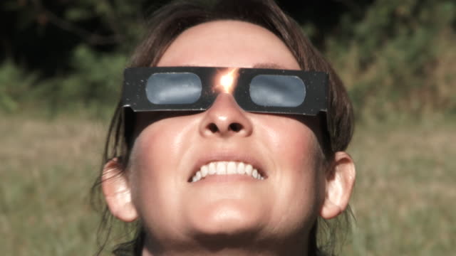 Woman With Protective Glasses Watches Solar Eclipse