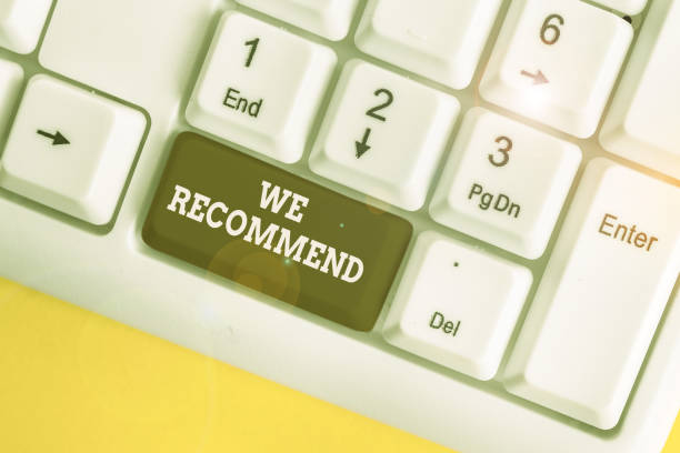 istock Text sign showing We Recommend. Conceptual photo suggest that someone or something would be good or suitable White pc keyboard with empty note paper above white background key copy space. 1215415097