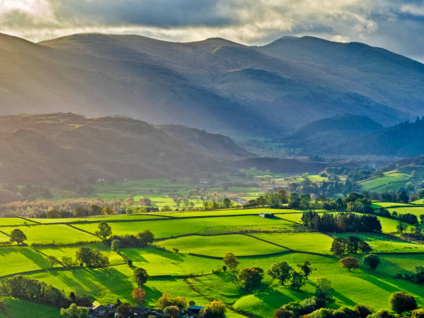 The Lake District region of the United Kingdom View of mountains surrounding Derwentwater at sunrise in the Lake District in the United Kingdom keswick photos stock pictures, royalty-free photos & images