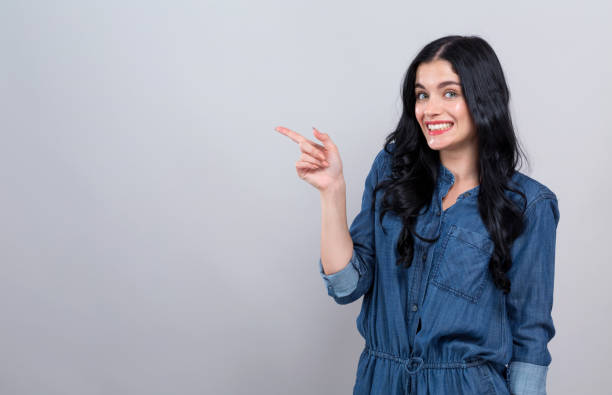 istock Young woman pointing at something 1215416724