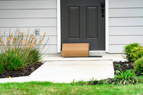 istock Package Delivery on Doorstep of Suburb home 1215419824