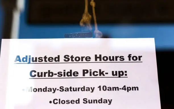 Photo of Handwritten Sign On Window: CURB-SIDE PICK-UP
