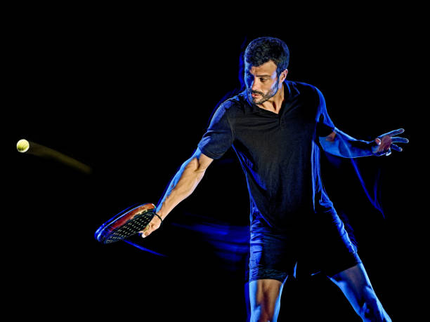 istock Paddle tennis player man light painting isolated black background 1215423675