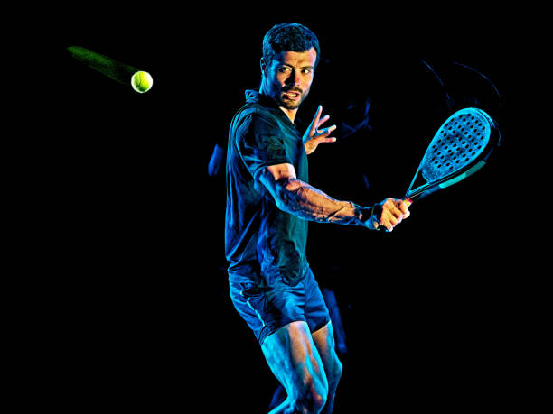 istock Paddle tennis player man light painting isolated black background 1215423687