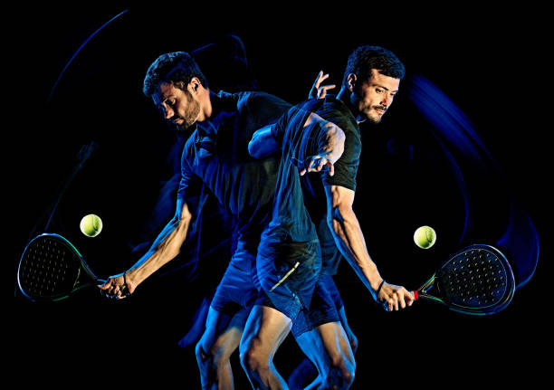 istock Paddle tennis player man light painting isolated black background 1215423693