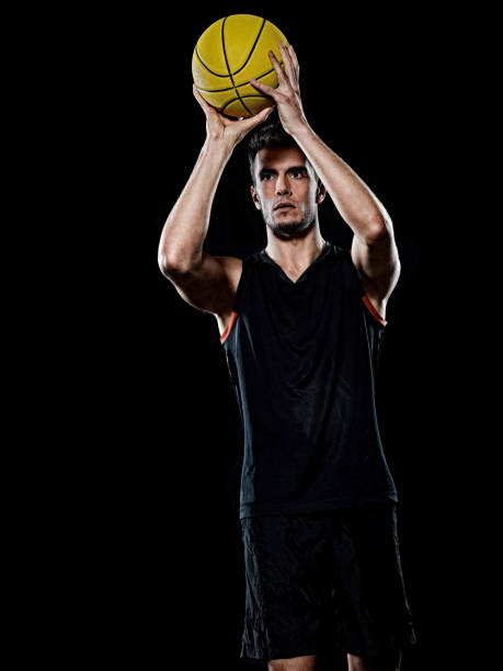 istock caucasian young basketball player manisolated black background 1215423740